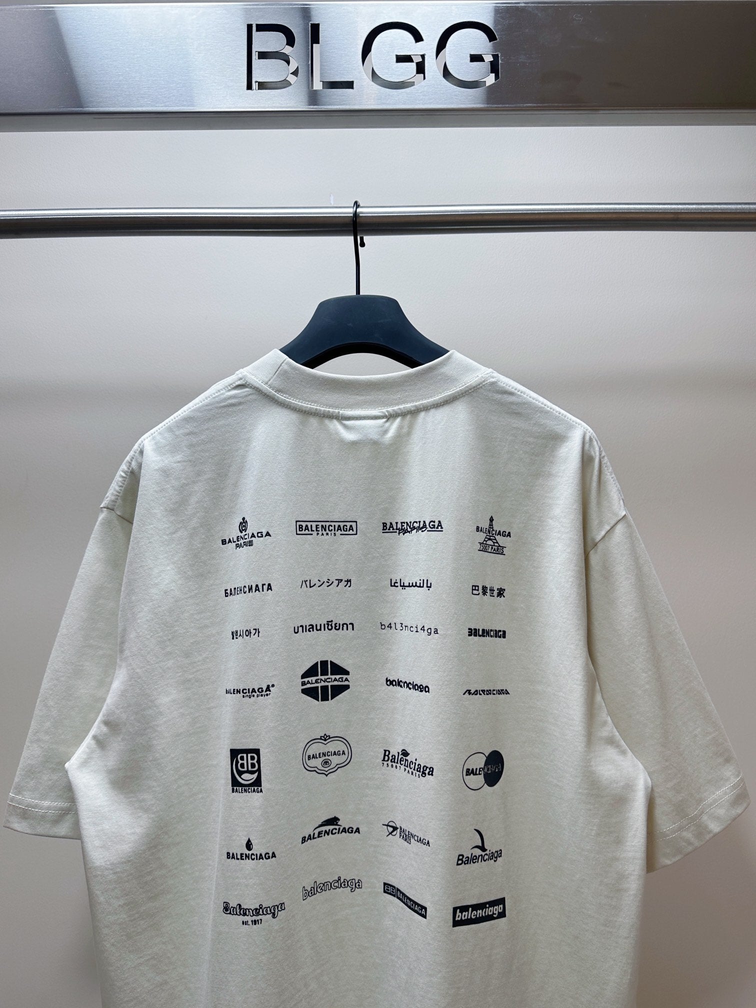 Balenciaga white short-sleeve T-shirt with black logos and icons across the back