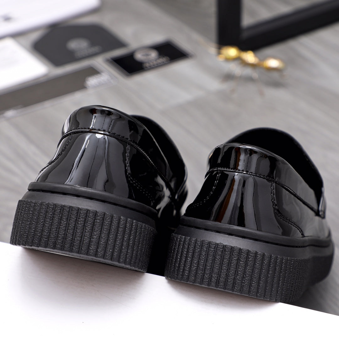 Versace patent loafers with textured platform heels and glossy black finish