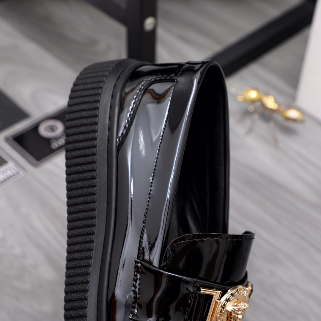 Versace patent loafer side view with ribbed platform edge and gold buckle