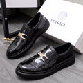 Versace luxury black patent loafers with gold buckle and textured rubber sole