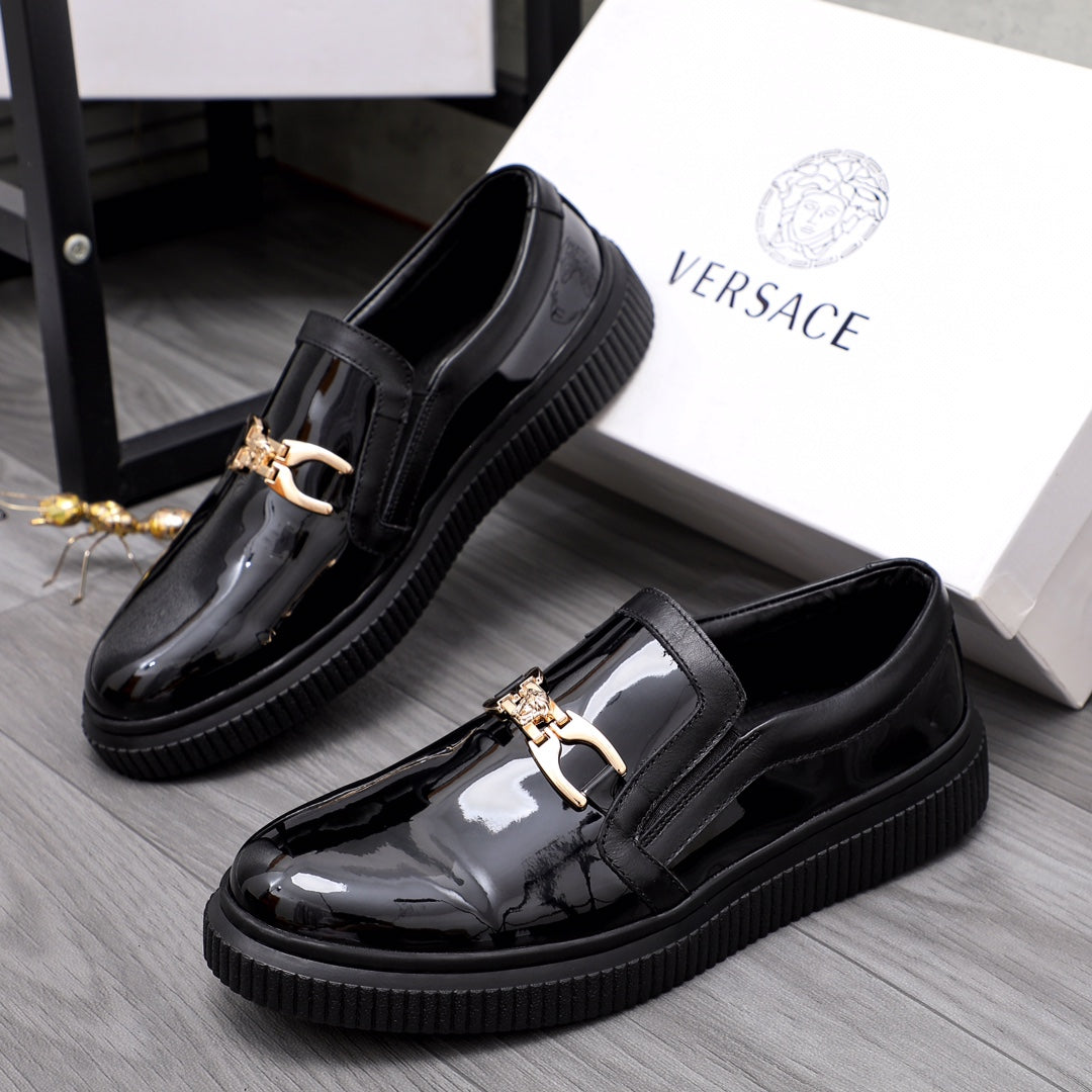 Versace luxury black patent loafers with gold buckle and textured rubber sole