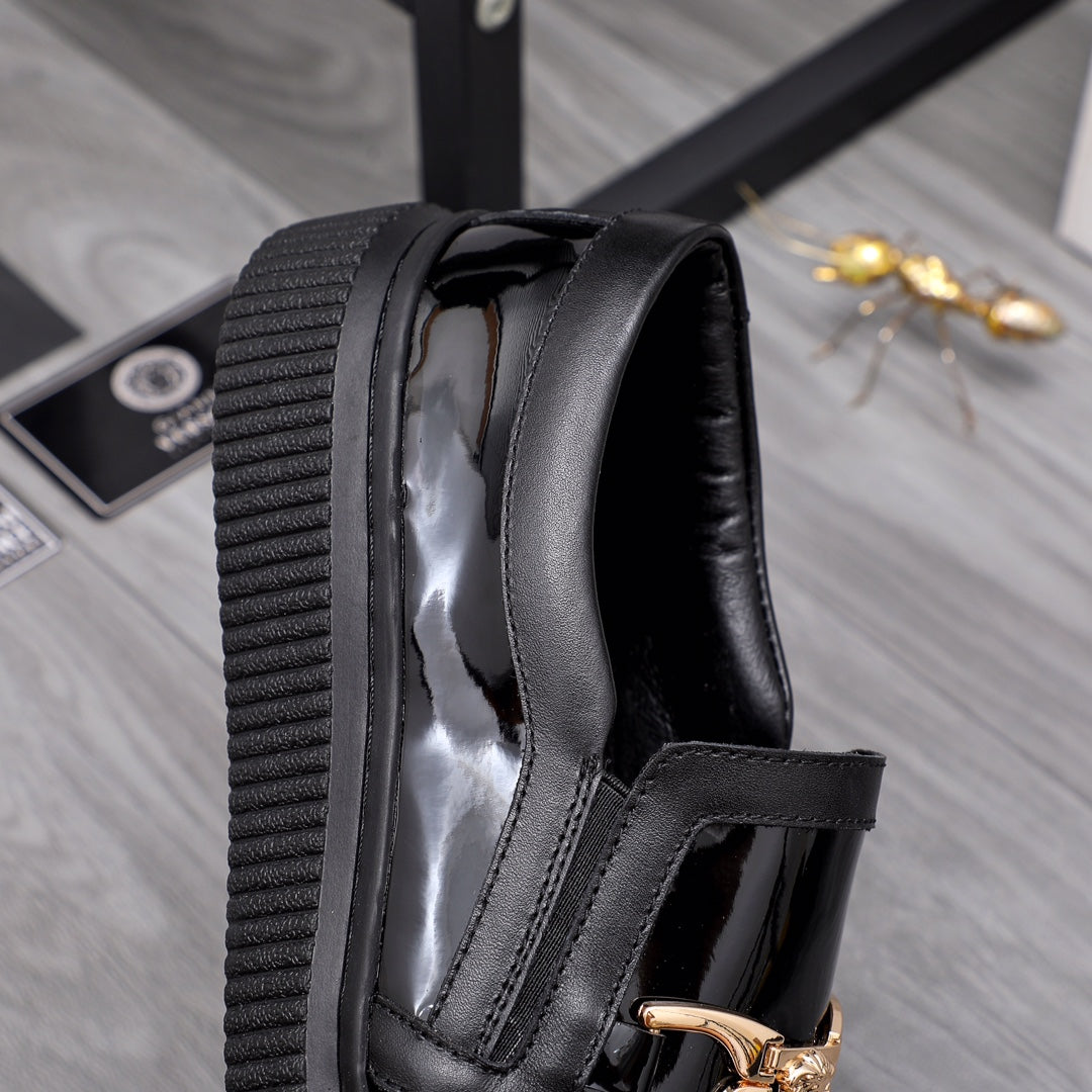 Versace luxury black patent loafers with wide strap and gold buckle