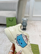Gucci unisex cream sneaker single, blue character graphic on side, lace-up