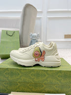 Gucci unisex white sneakers with lace-up front, chunky sole, cartoon bear applique