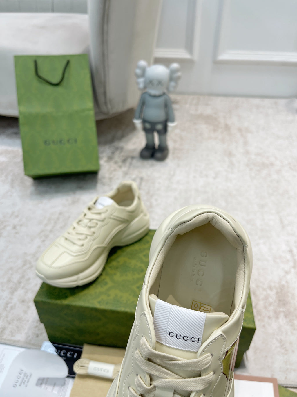 Gucci unisex white sneakers showing interior label and side profile, lace-up