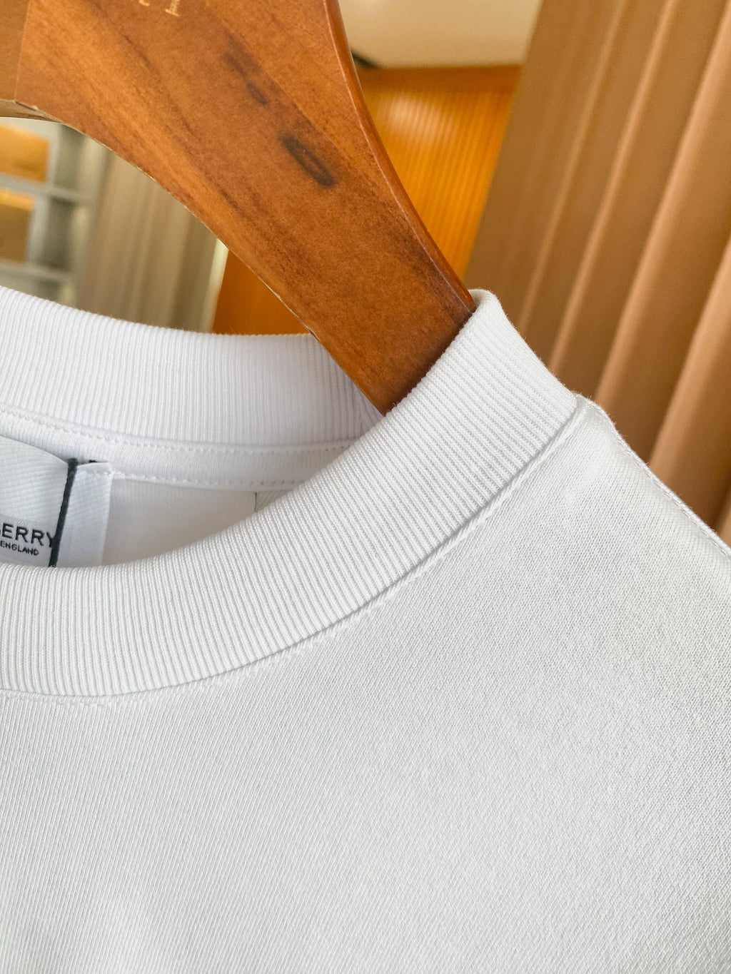 White T-shirt neckline with ribbed crew collar and smooth knit collar band.