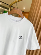 White crewneck T-shirt with short sleeves and small black chest logo near collar.