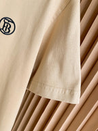 Light beige T-shirt sleeve with small chest logo and stitched hem detail