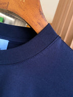 Navy crew-neck T-shirt neckline and collar seam detail.
