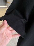 Burberry black T-shirt fabric close-up with stitched sleeve hem