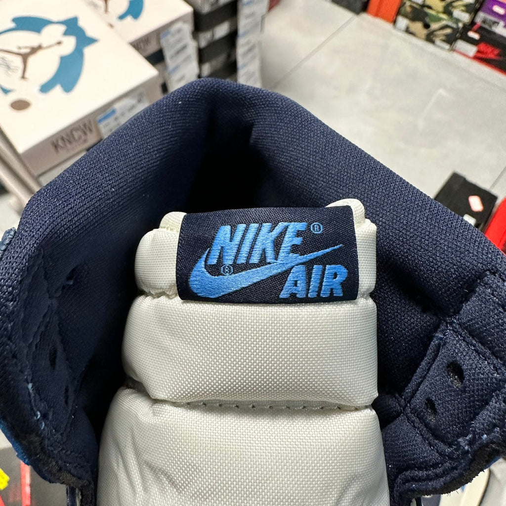 Nike Air tongue label on navy and white Air Jordan 1 high-top sneaker
