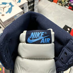Nike Air tongue label on navy and white Air Jordan 1 high-top sneaker
