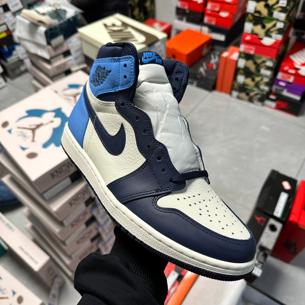 Air Jordan 1 high-top sneaker with navy laces, light blue, and white side panels