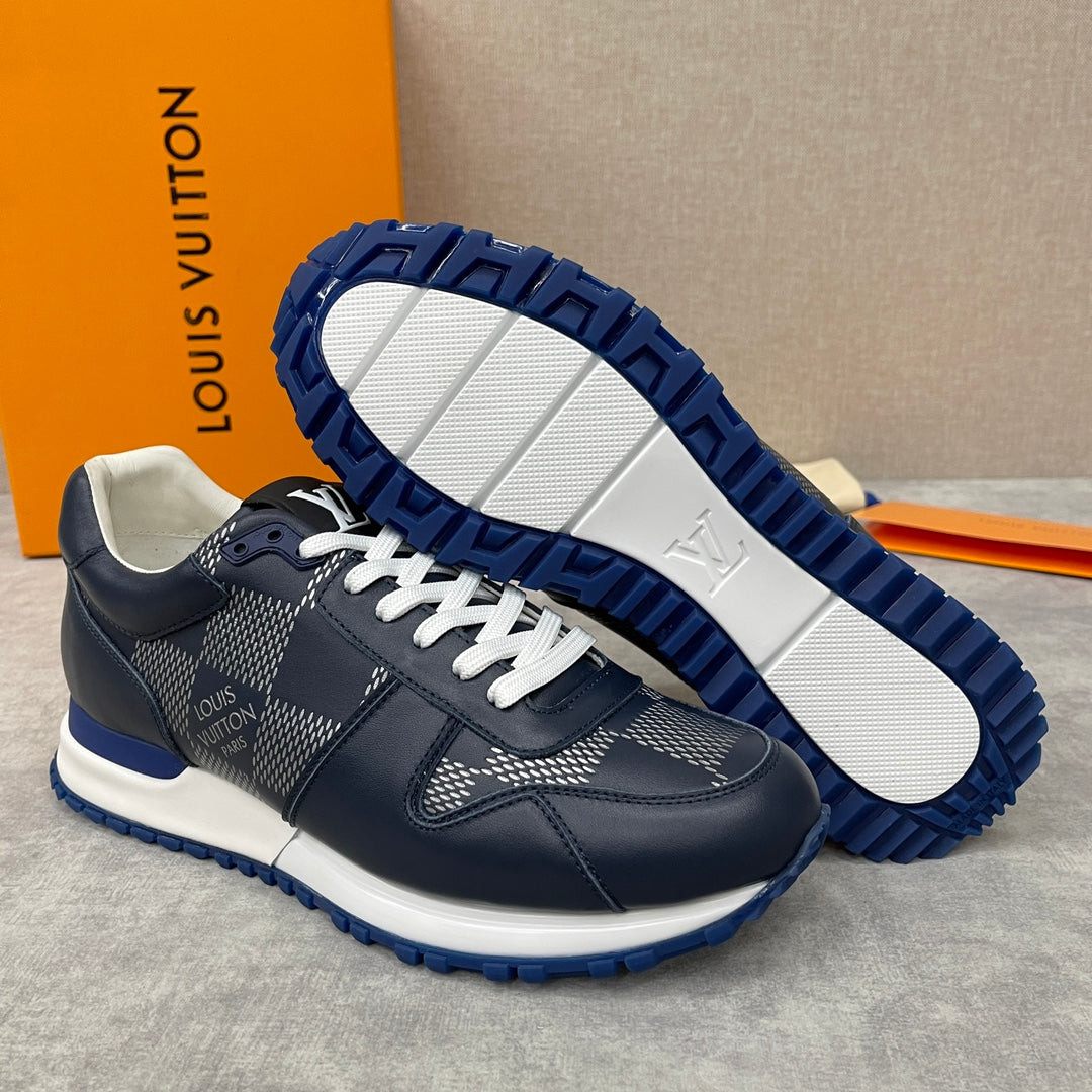 Navy Louis Vuitton low-top sneakers with white laces and patterned panels, rugged blue outsole