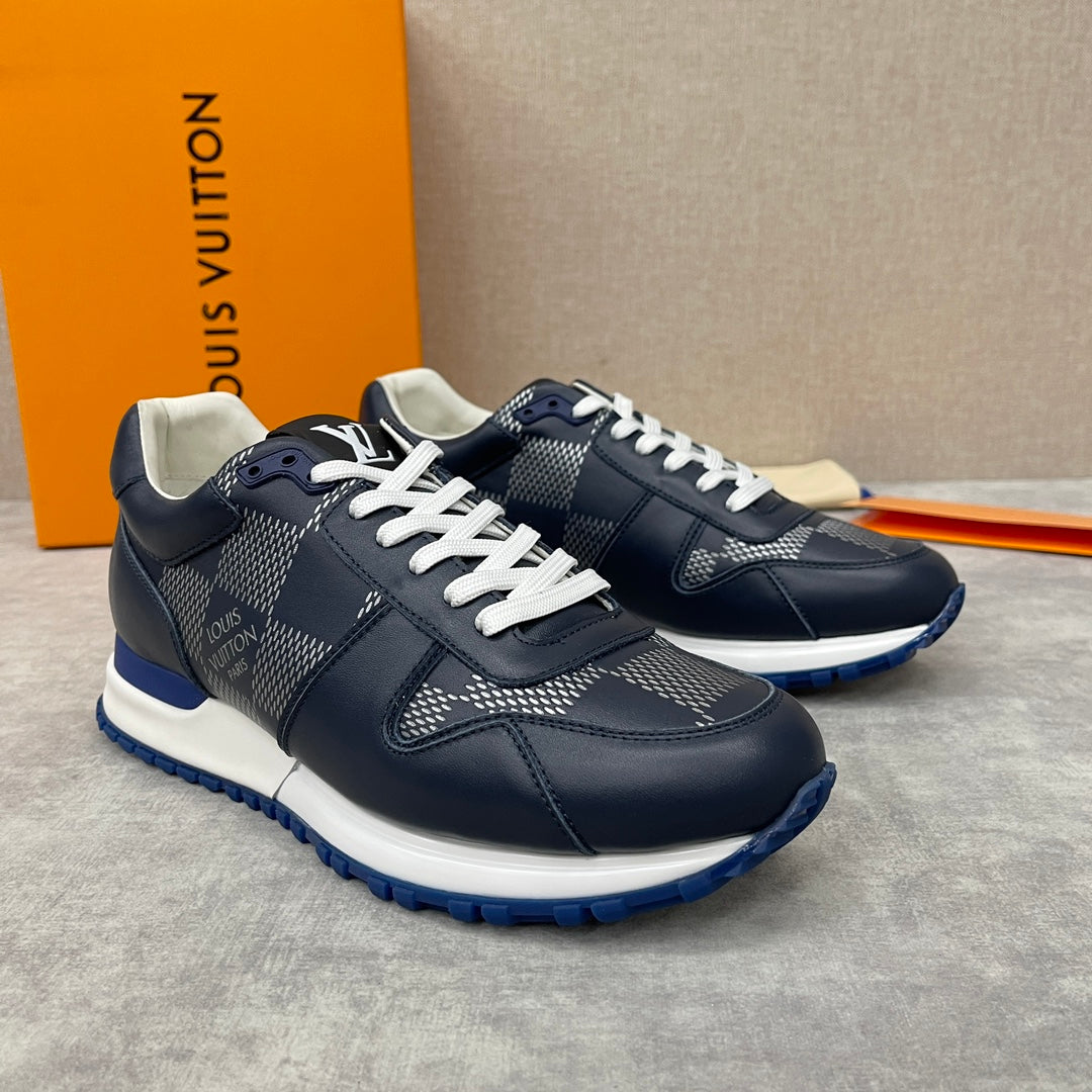 Navy Louis Vuitton low-top sneakers with white laces, patterned panels and blue sole
