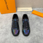 Pair of black low-top sneakers with iridescent side panels and lace-up closure.