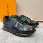 Low-top sneakers with black leather look, iridescent blue-green panels, lace-up.