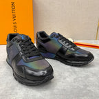 Black low-top sneakers with iridescent multicolor panels and lace-up front.