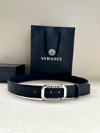 Versace belt in dark with embossed logo pattern and silver-tone round buckle.