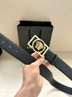Versace belt with dark patterned strap and gold-tone square buckle with lion emblem