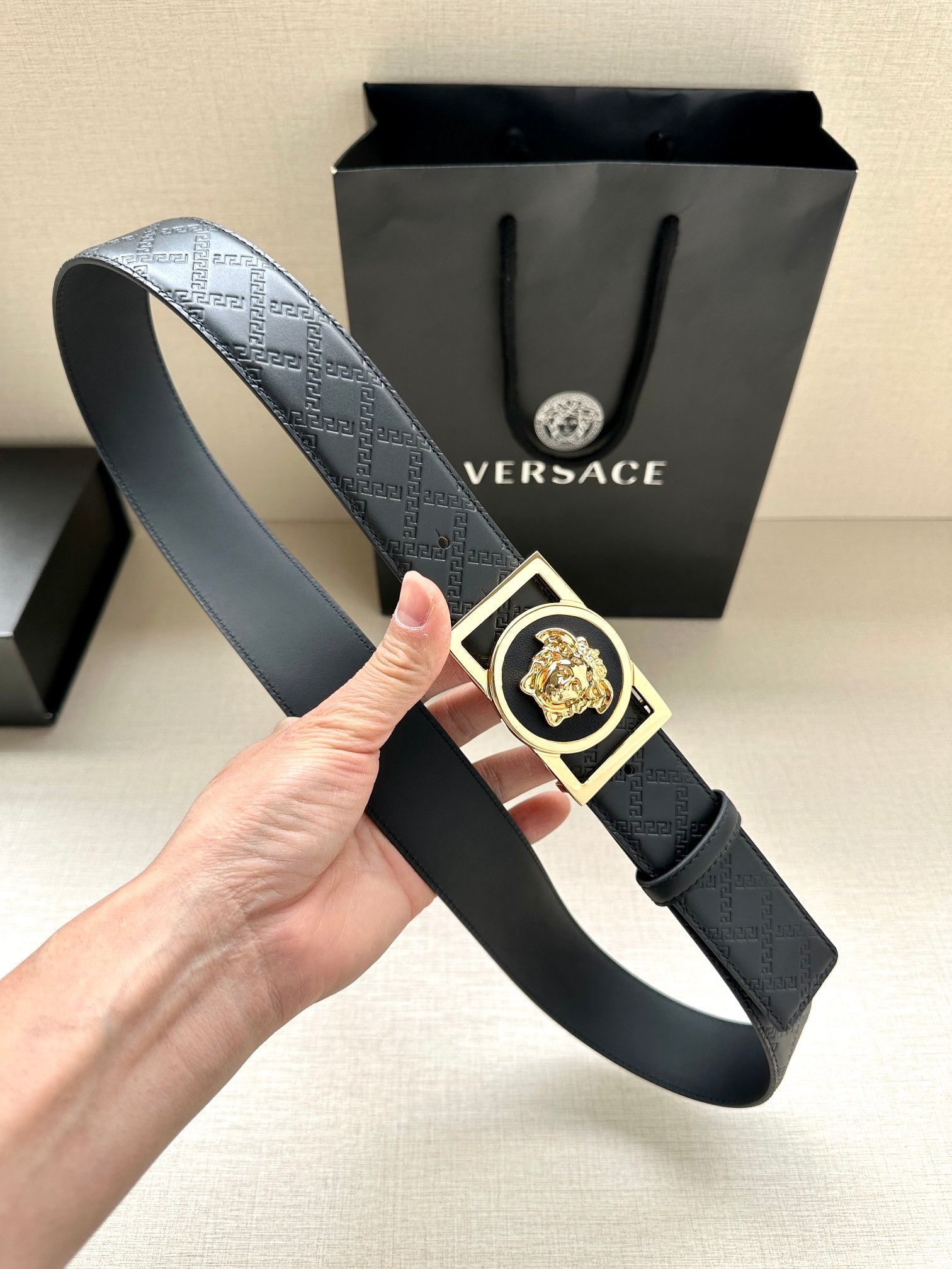 Versace belt with dark patterned strap and gold medallion silver-tone square buckle