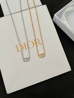 Silver-tone and gold-tone pendant necklaces on white gift cards