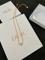 Gold-tone pendant necklace with interlocking motif and shorter chain