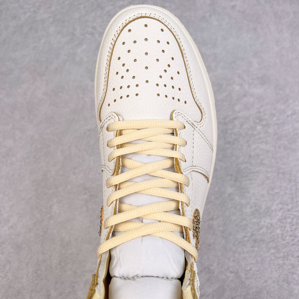 White high-top sneaker with perforated toe box and cream-yellow lace pattern.