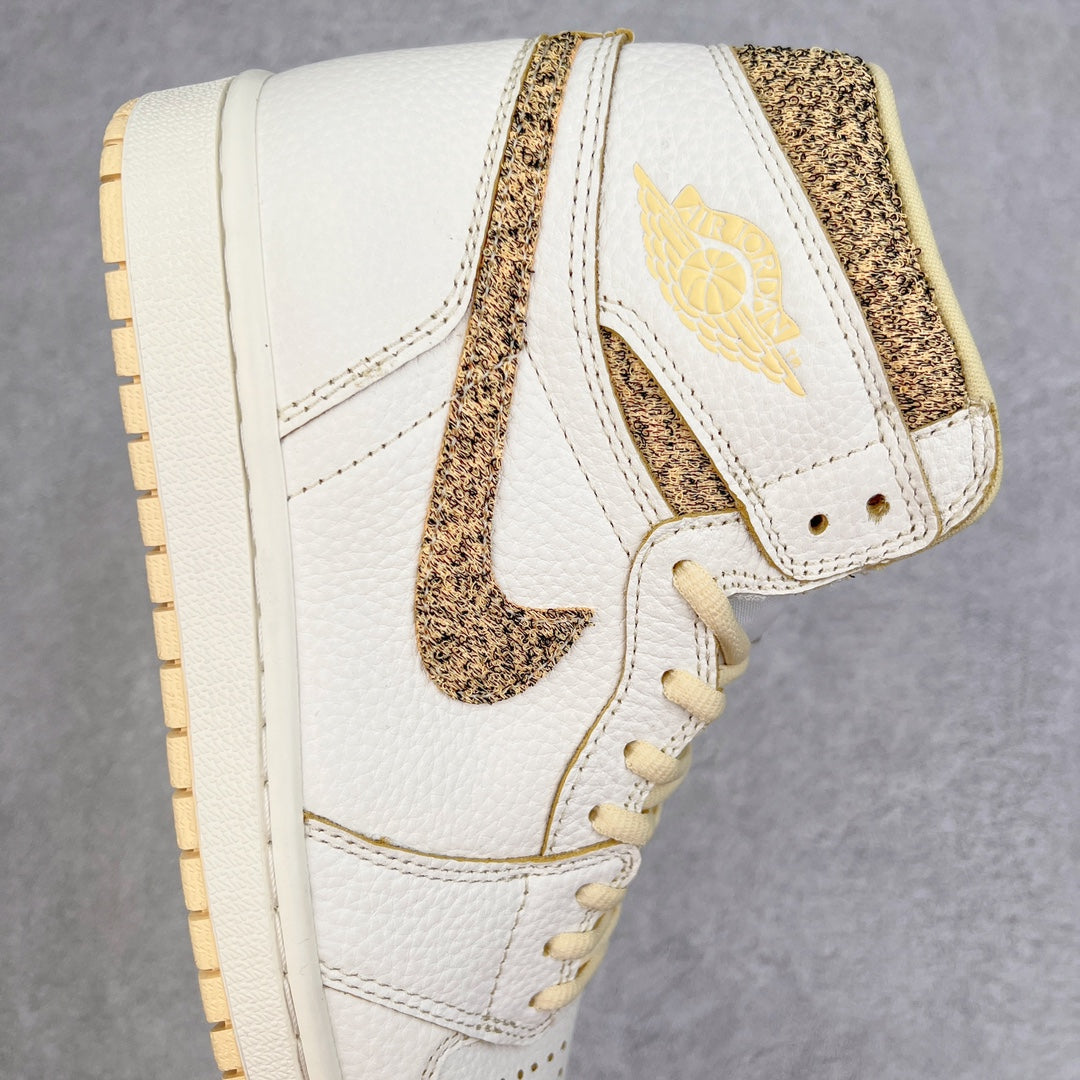Side view of white high-top sneaker with brown speckled strap, swoosh, and stitched panels.