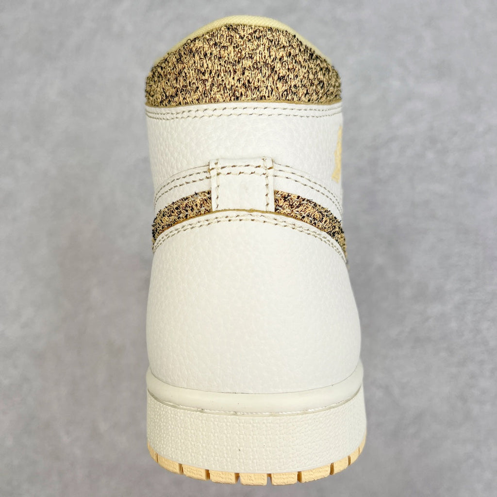 Back view of white high-top sneaker with brown speckled collar and padded heel.