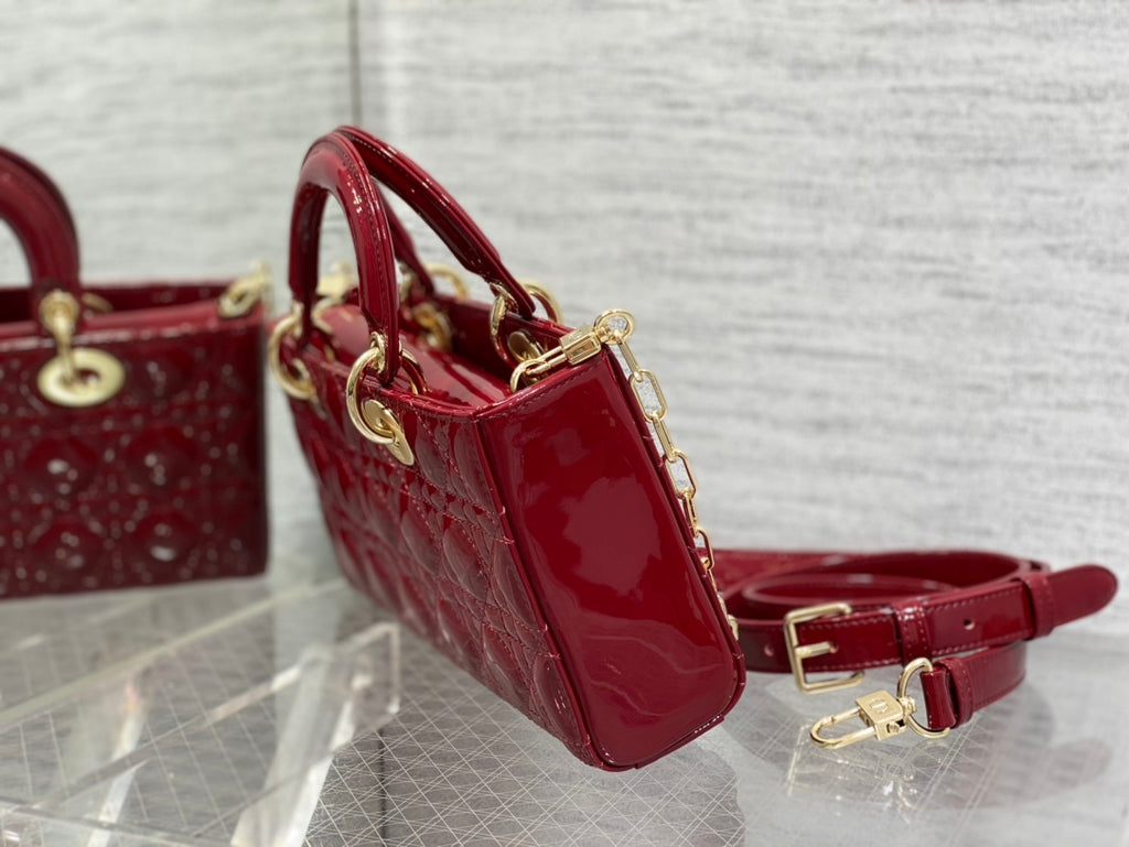 Dior handbag deep red glossy patent with small side pouch and adjustable shoulder strap.