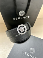 Versace belt with embossed strap and lion medallion buckle on gray box