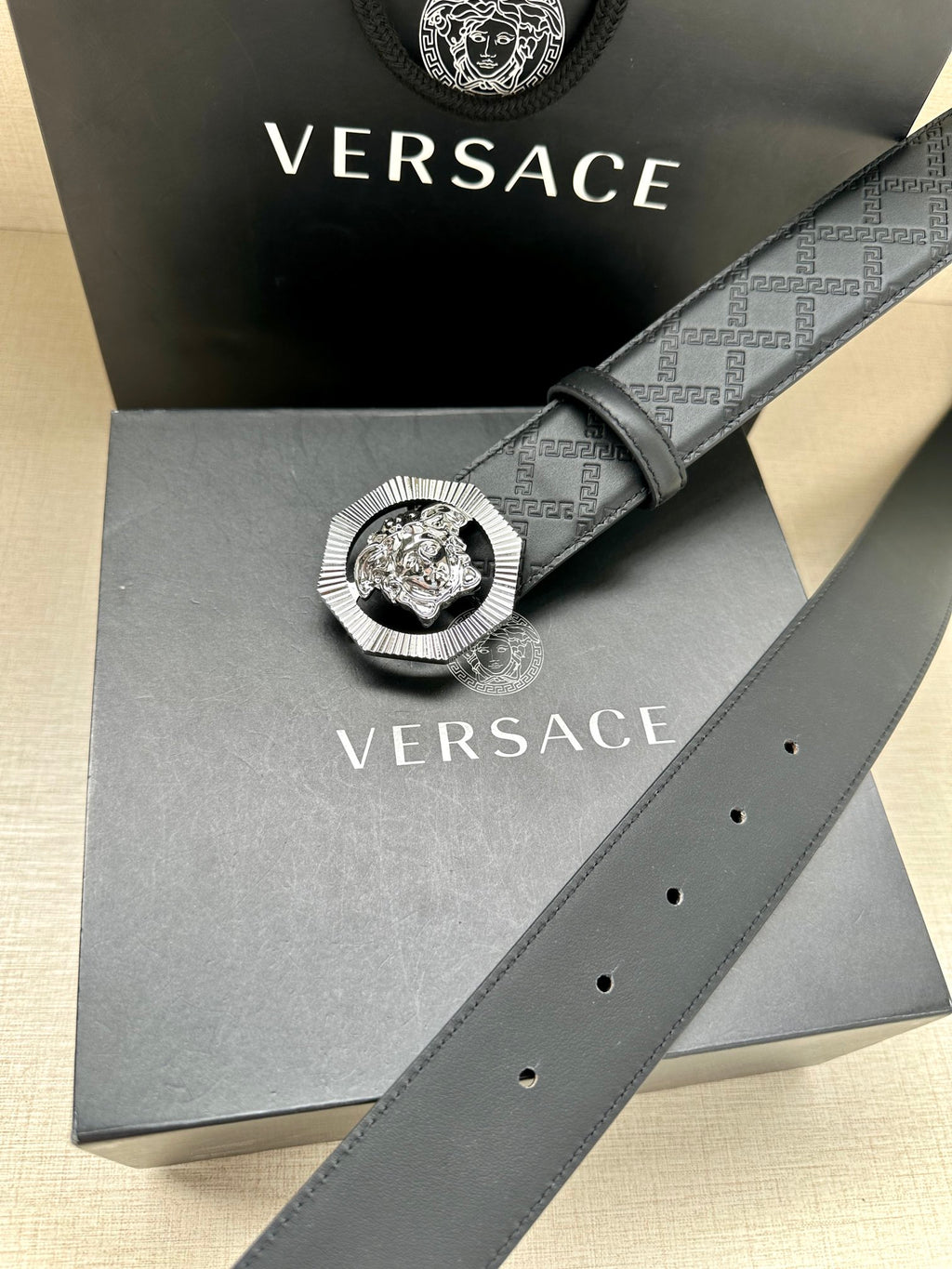 Versace belt with embossed strap and round lion medallion buckle on display box