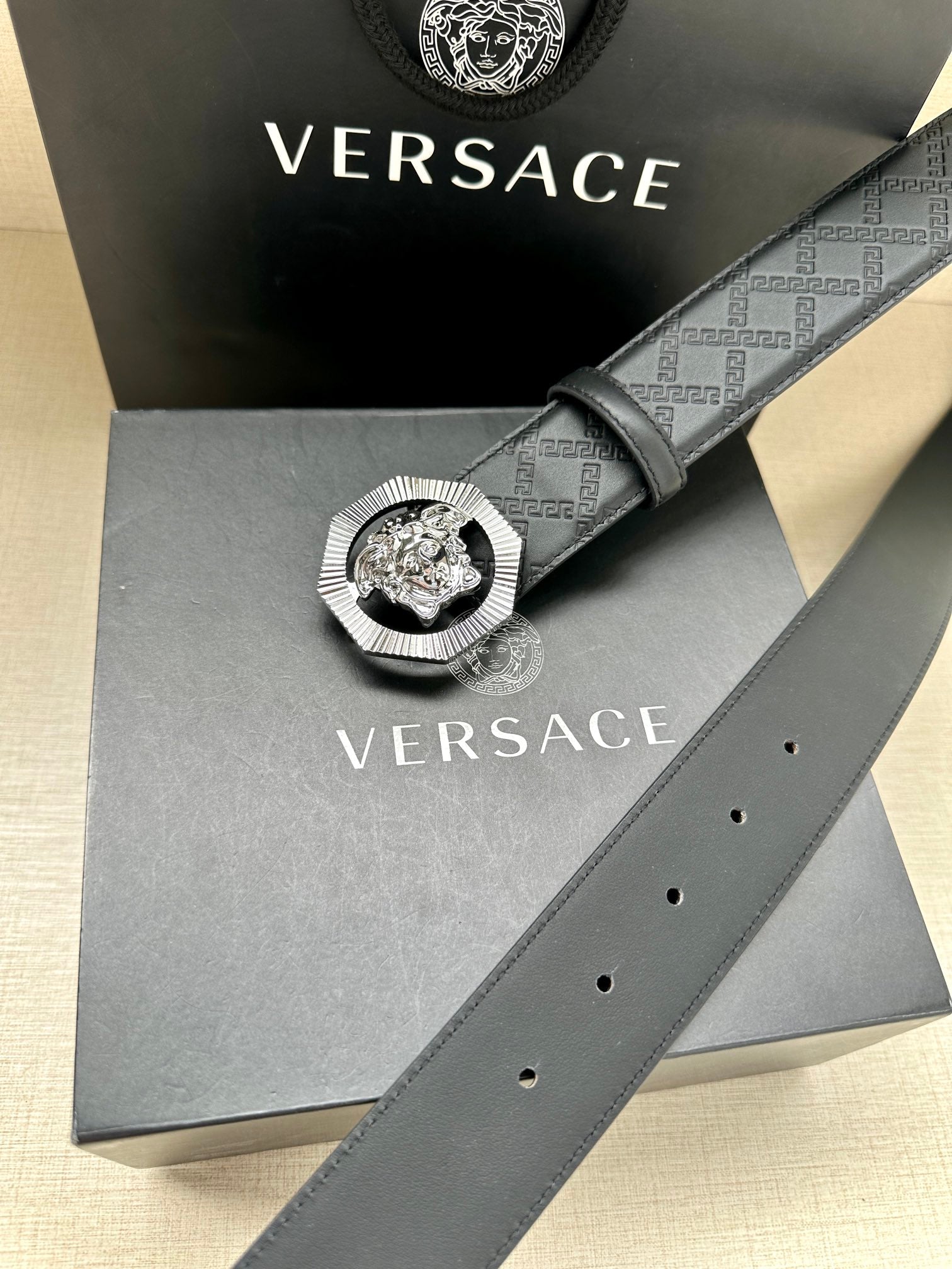 Versace belt with embossed strap and round lion medallion buckle on display box