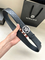 Versace belt held in hand, embossed monogram strap with lion medallion buckle