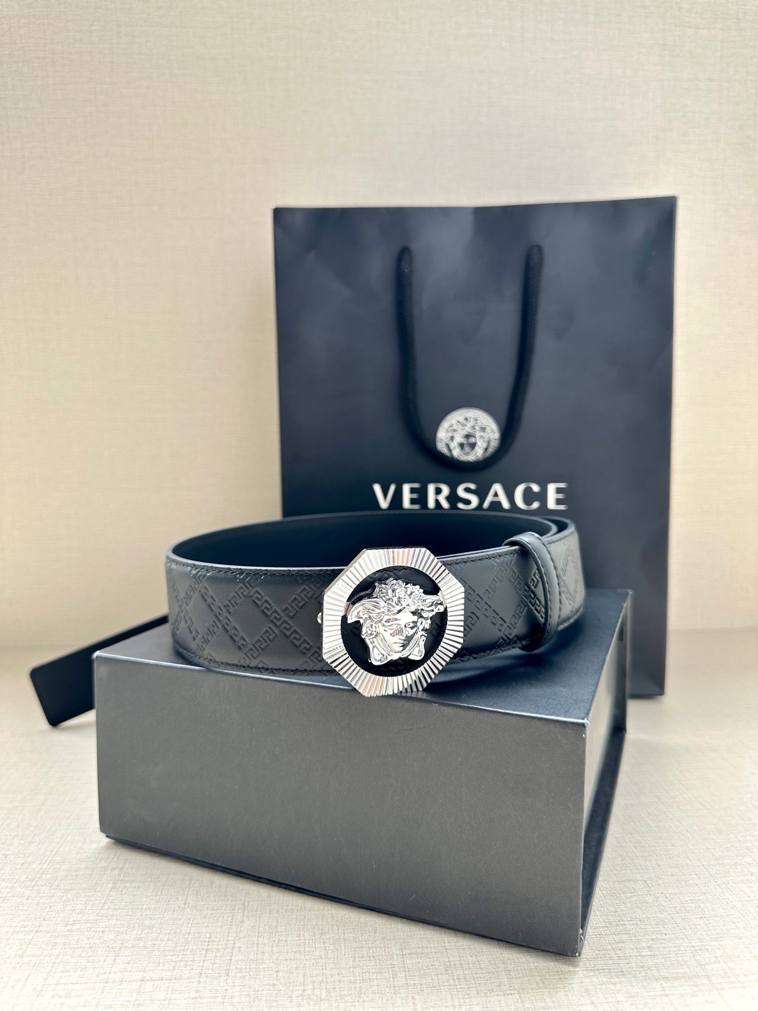 Versace belt with embossed strap and lion medallion buckle on box