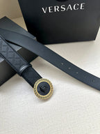 Dark navy leather belt with long straps and circular medallion buckle