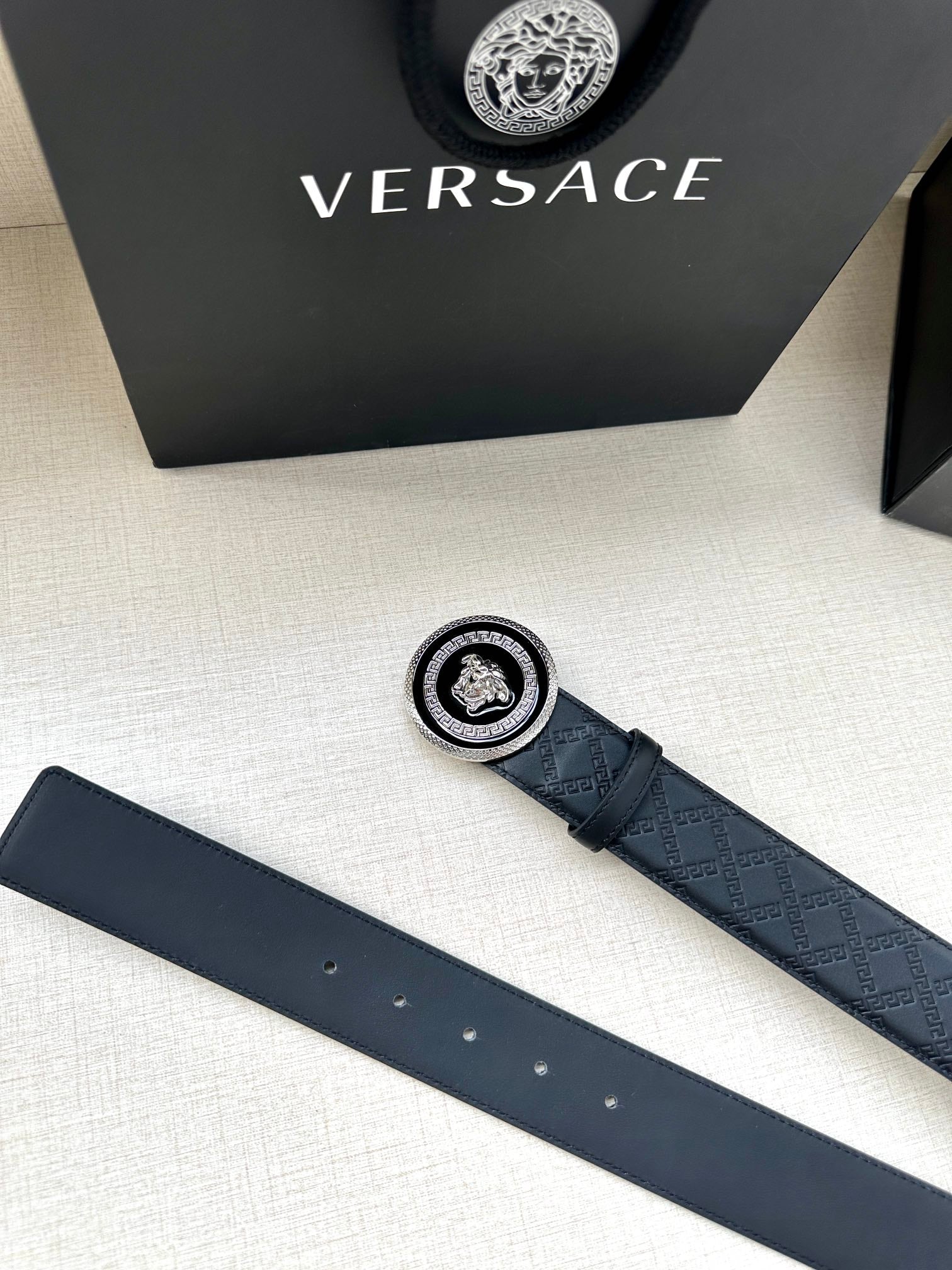 Versace belt accessories view: dark embossed strap with round medallion buckle