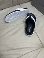 Back view of black thong sandal showing ribbed white outsole tread