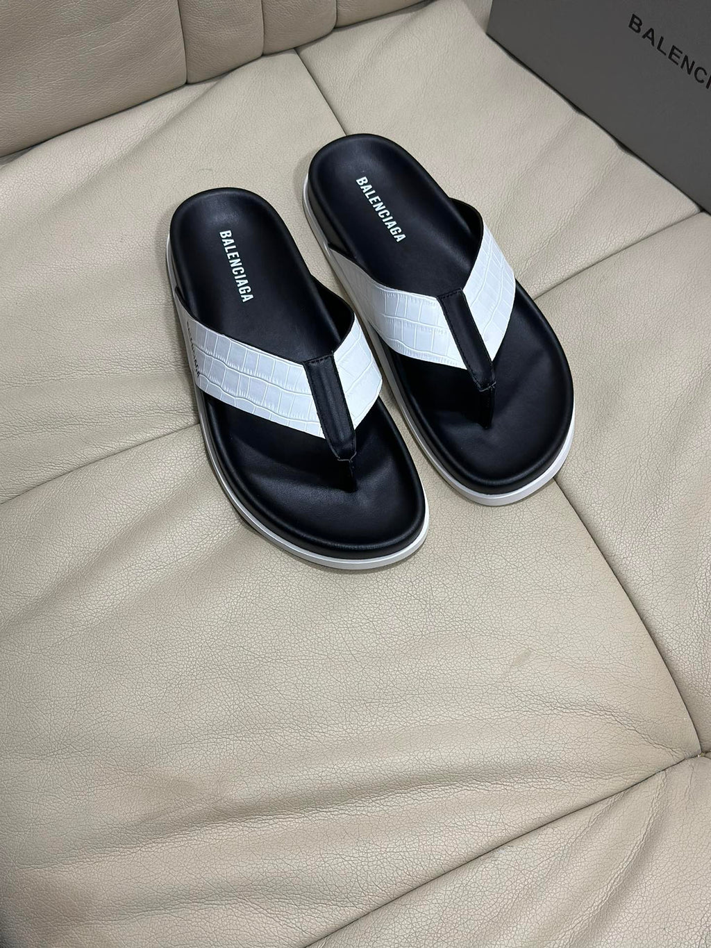 Black and white flip-flop sandals with thong strap and cushioned footbed