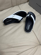 Black-and-white thong sandals shown from side with thick molded sole