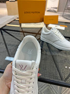 White Louis Vuitton sneakers showing inner heel lining and lace-up closure.