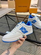 Louis Vuitton low-top sneakers, white leather with blue accent sole and lace-up front