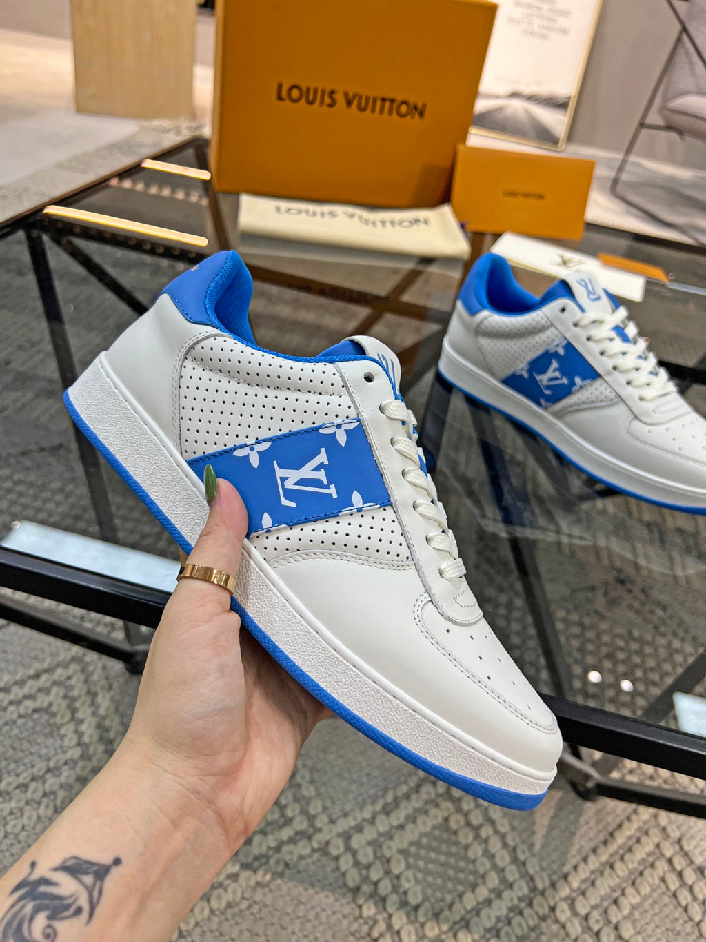 Louis Vuitton low-top sneakers, white leather with blue logo panel and perforated toe