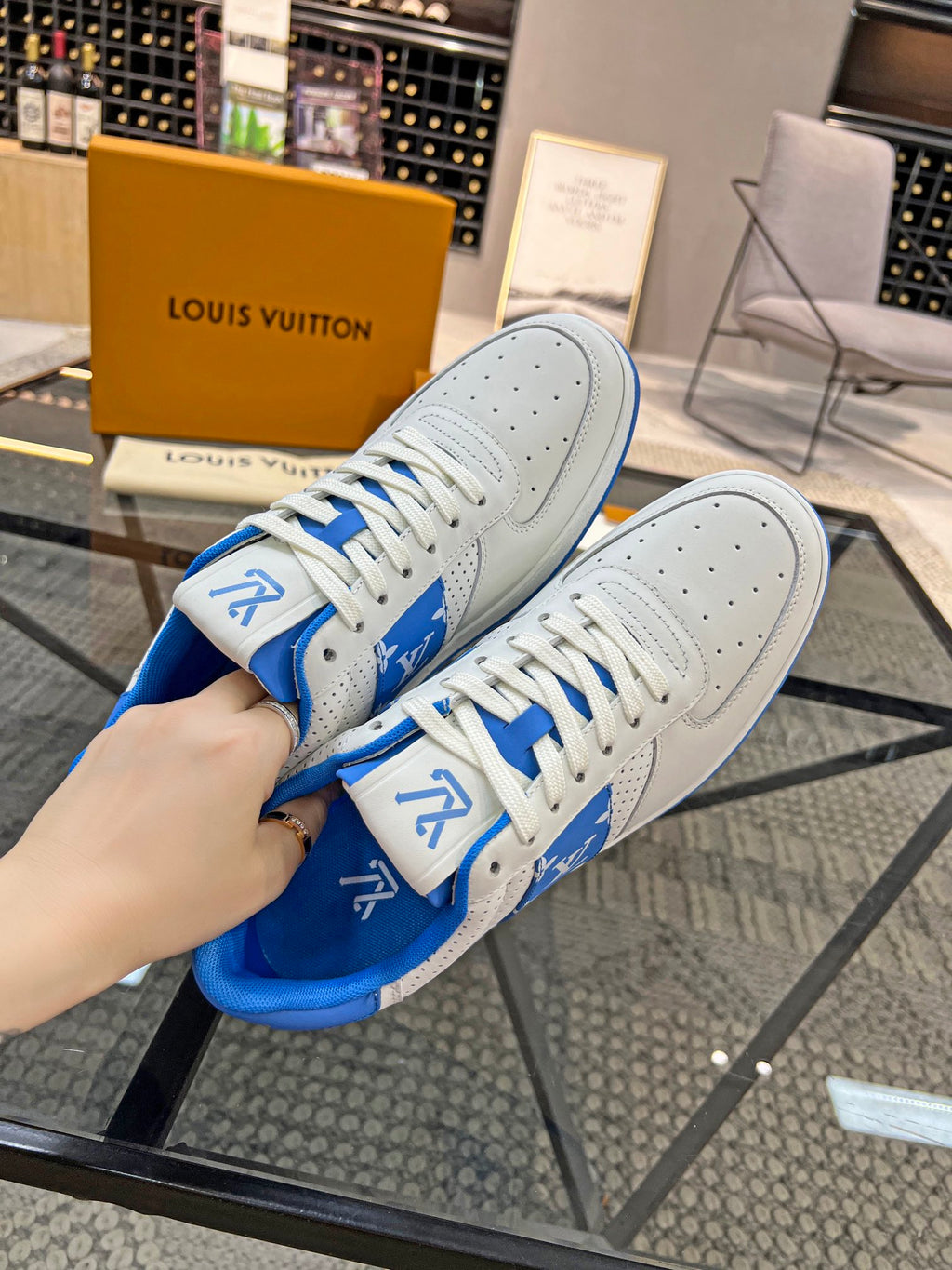 Louis Vuitton low-top sneakers from side, white leather with blue heel lining and laces