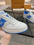 Louis Vuitton low-top sneakers, white leather with blue logo panel and perforated toe