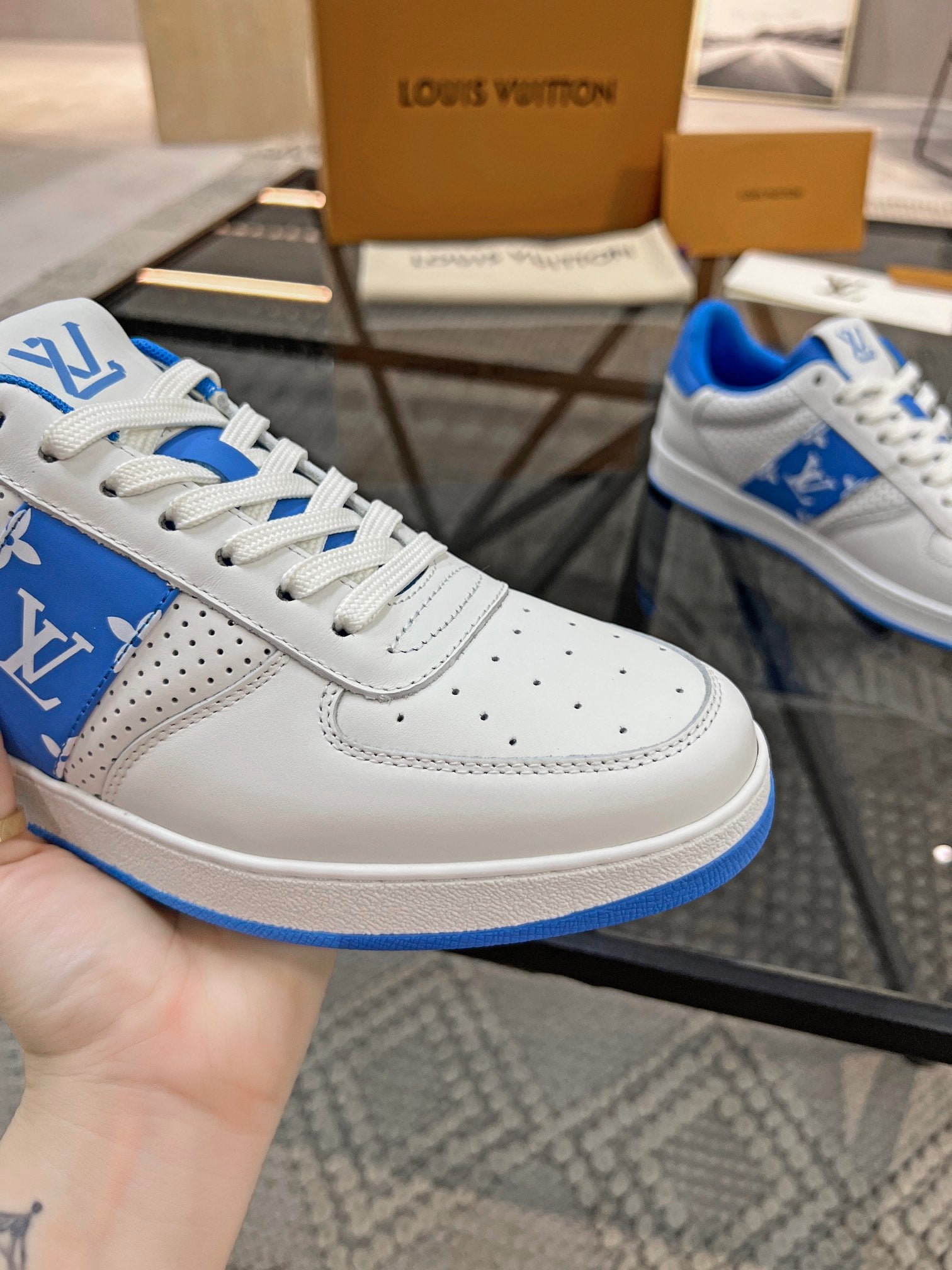 Louis Vuitton low-top sneakers, white leather with blue logo panel and perforated toe