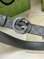 Gucci belt buckle close-up on dark gray GG canvas strap with silver-tone hardware