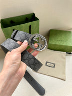 Gucci belt with dark gray GG monogram strap and large silver-tone logo buckle