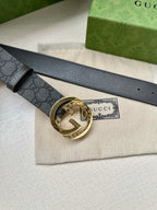 Gucci belt with dark gray GG monogram strap and gold-tone circular logo buckle